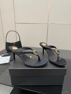 Women’s black high-heel thong sandals with jeweled gold-toned embellishments and thin strap.