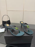 Women's teal heeled sandals with thin heel and jeweled floral strap detail