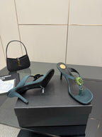 Women's teal heeled sandals with jeweled floral buckle detail and open toe