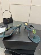 Women's teal heeled thong sandals with jeweled floral embellishment on strap