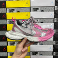 Balenciaga unisex sneakers in pink and gray with chunky white sole and lace-up front.