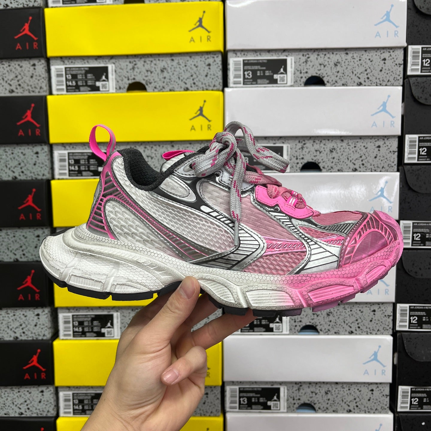 Balenciaga unisex sneakers in pink and gray with chunky white sole and lace-up front.