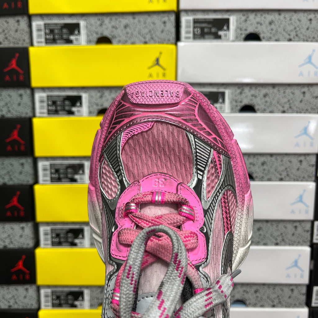 Balenciaga unisex sneaker front view with pink tongue, gray laces, and mesh-texture upper.
