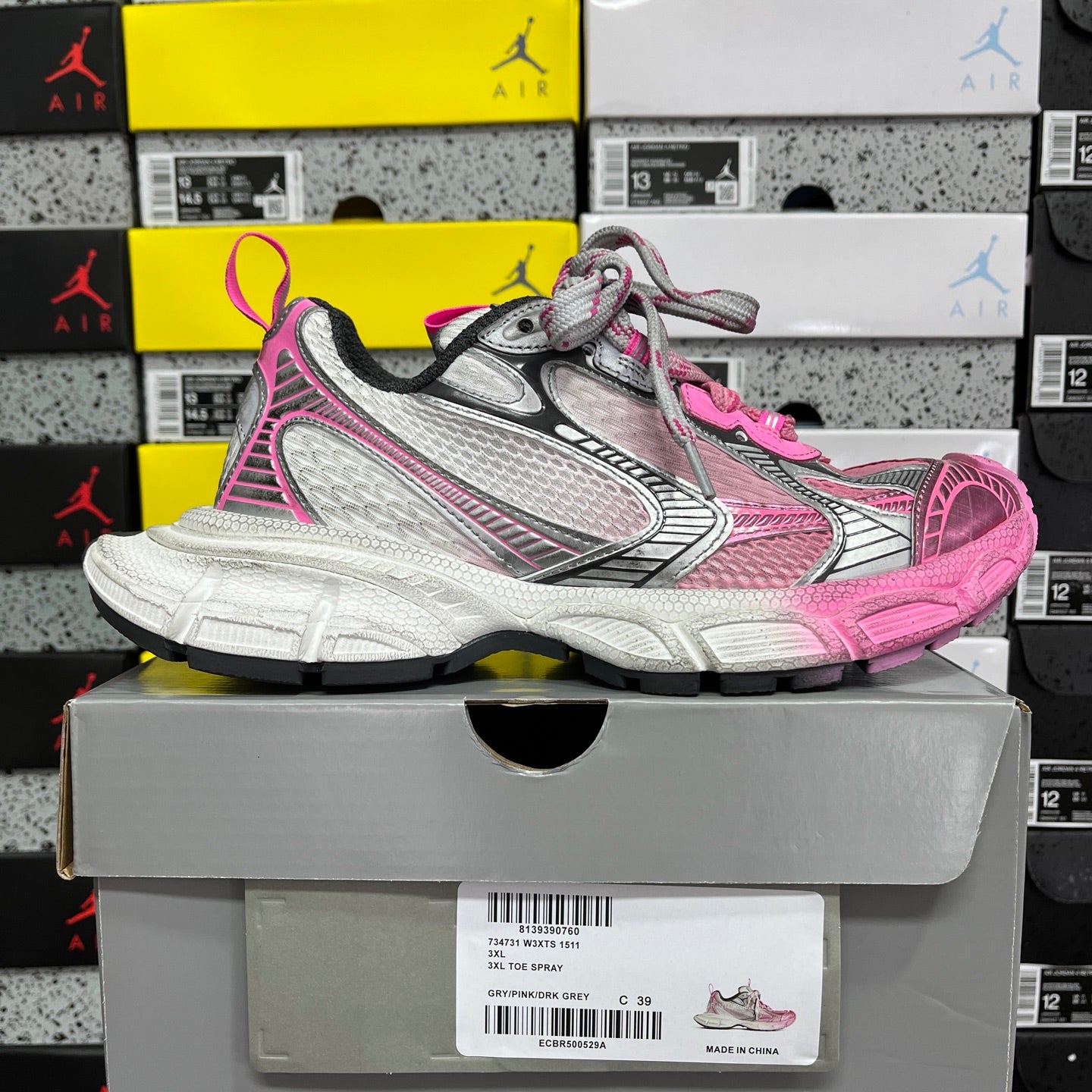 Balenciaga unisex sneakers, pink and gray upper with textured details and thick white sole.