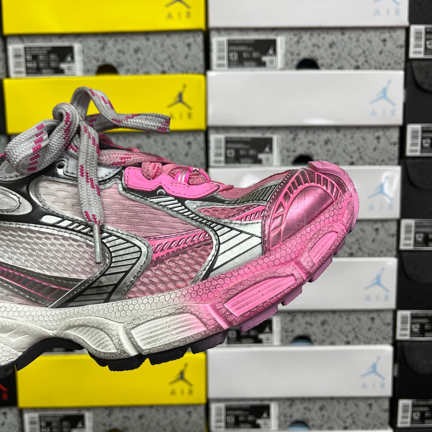 Balenciaga unisex sneakers side view with pink-and-gray panels and chunky treaded sole.