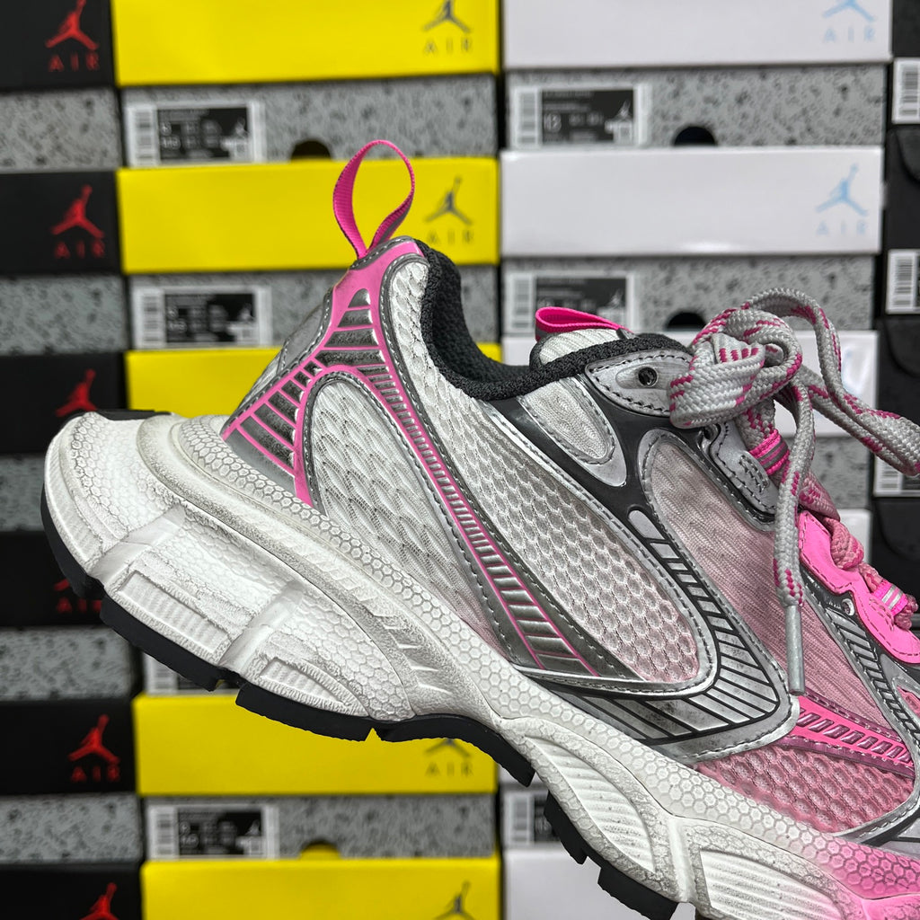 Balenciaga unisex sneakers angled view, pink accents with gray mesh panels and white sole.