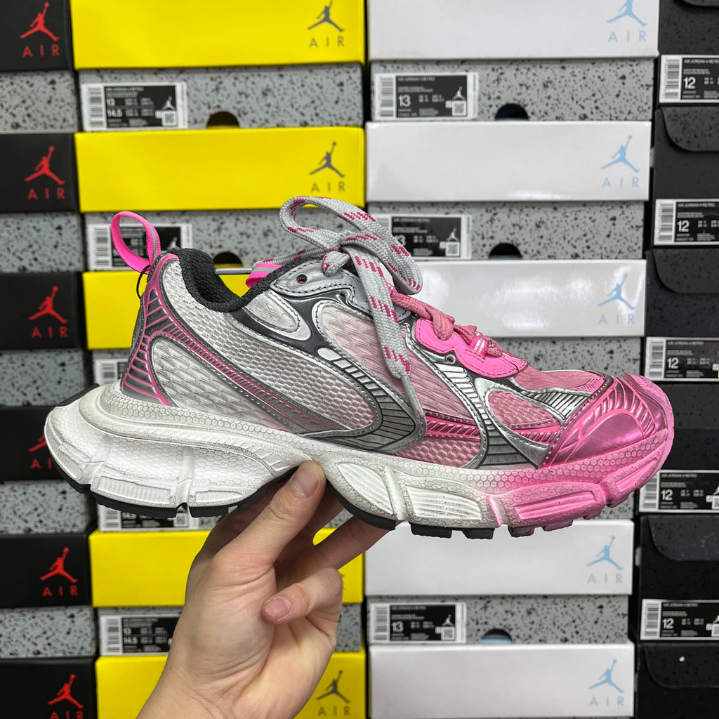 Balenciaga unisex sneakers front/side view in pink and gray with lace-up closure.