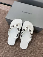 White thong sandals with studded straps and silver-tone buckle details