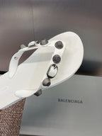 White thong sandal with studded strap and silver-tone hardware detail