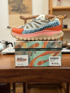 Moncler luxury sneakers in light gray mesh with orange panels, pink sole