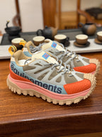Light gray mesh sneakers with orange accents and pink midsole, lace-up