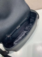 Prada leather crossbody bag interior, black lining and zipper pocket close-up