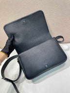 Prada leather crossbody bag open, black, with strap and two snap buttons