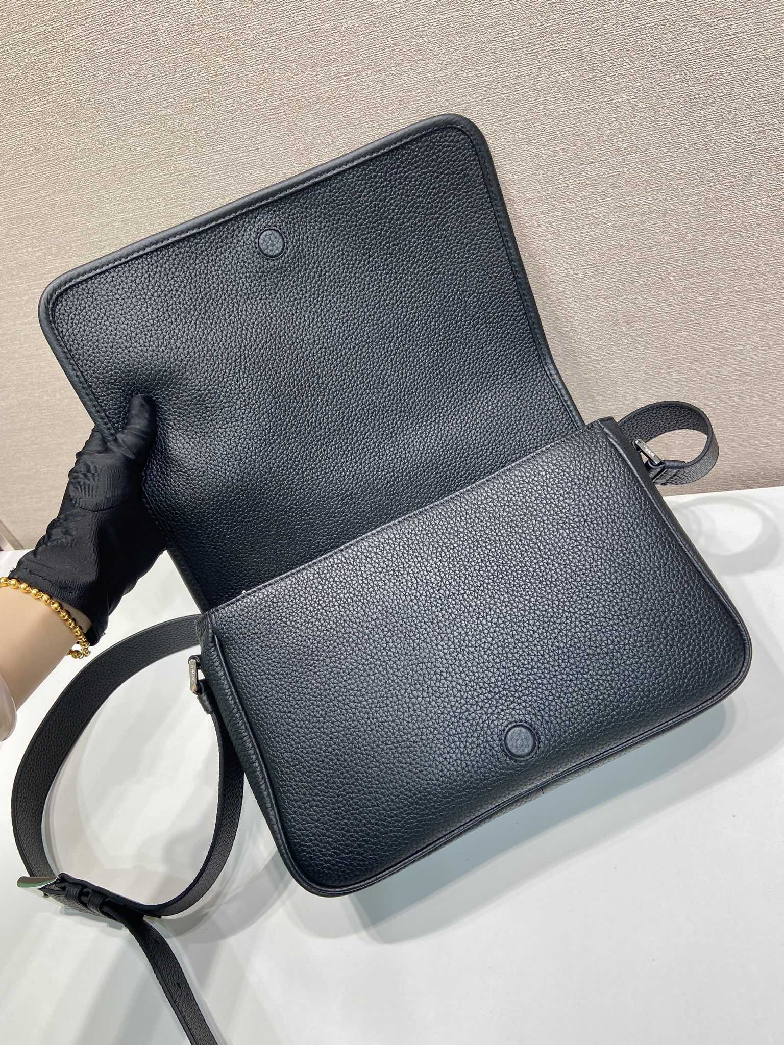 Prada leather crossbody bag open, black, with strap and two snap buttons