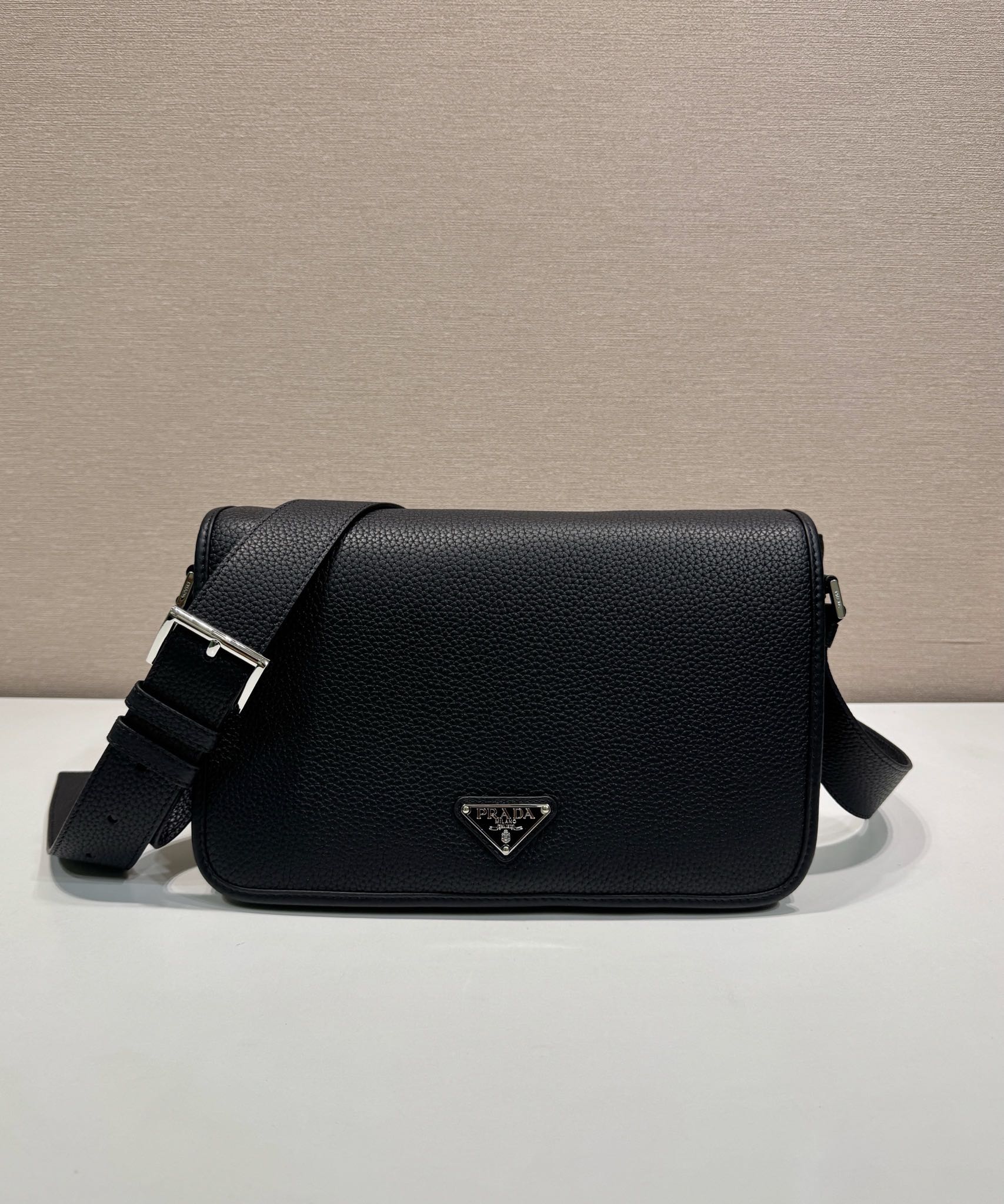 Prada leather crossbody bag with flap and silver triangle logo, black