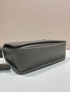 Prada leather crossbody bag side view with gusseted shape and smooth zipper closure