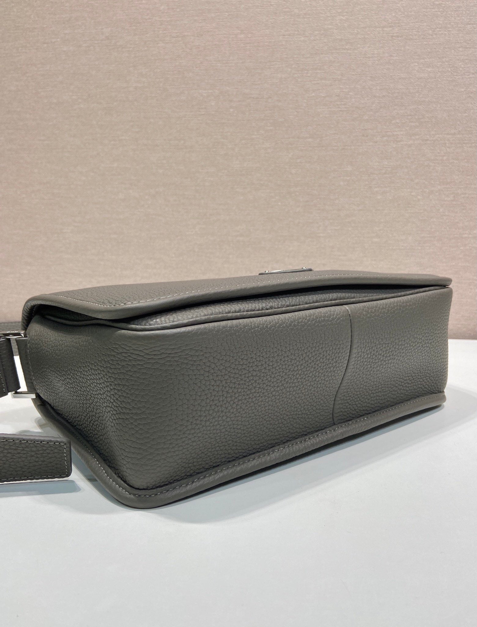 Prada leather crossbody bag side view with gusseted shape and smooth zipper closure