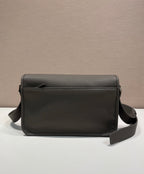 Prada leather crossbody bag with flap front, smooth grain texture, and side strap