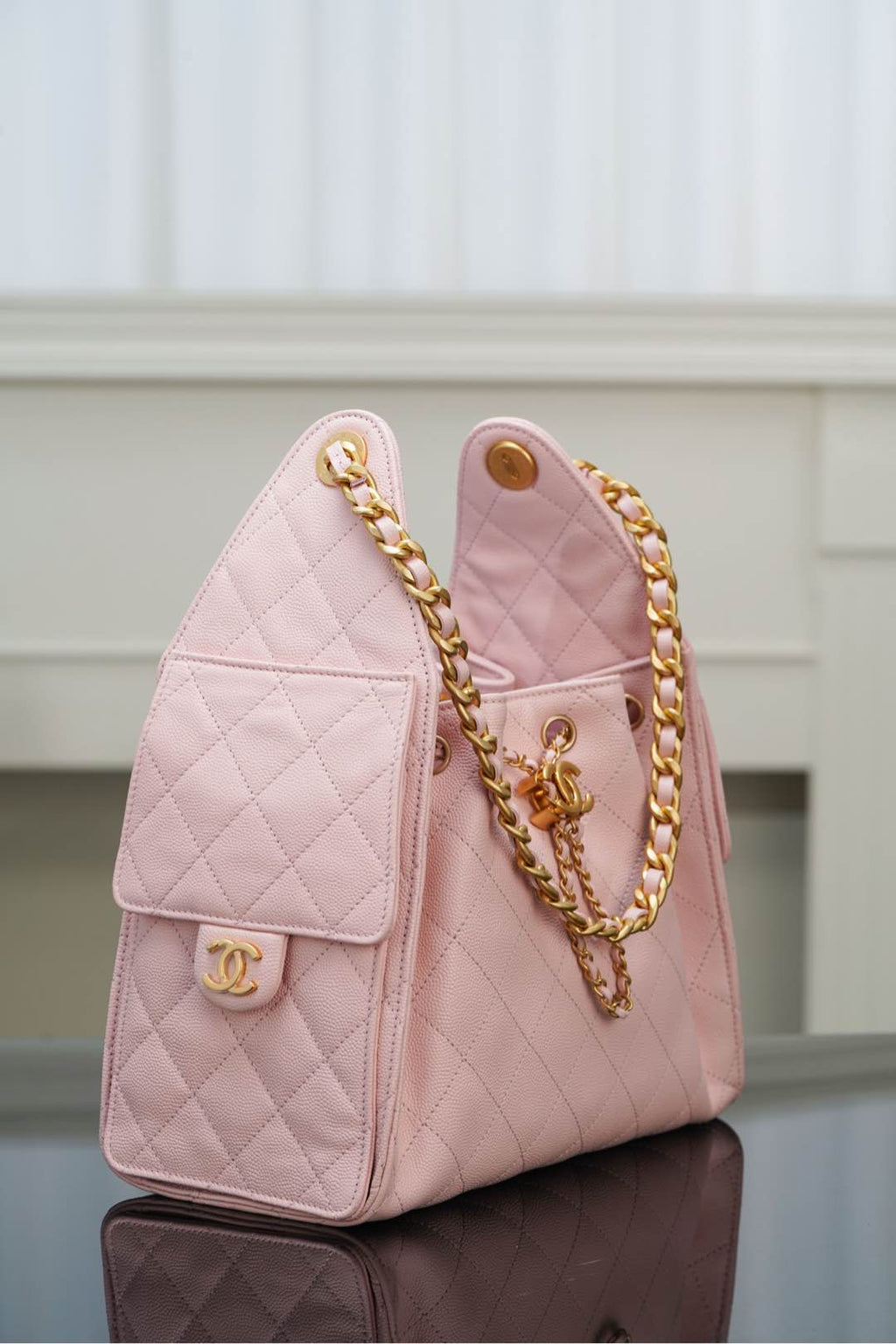 Chanel pink quilted mini bag with gold chain shoulder strap and side logo plate