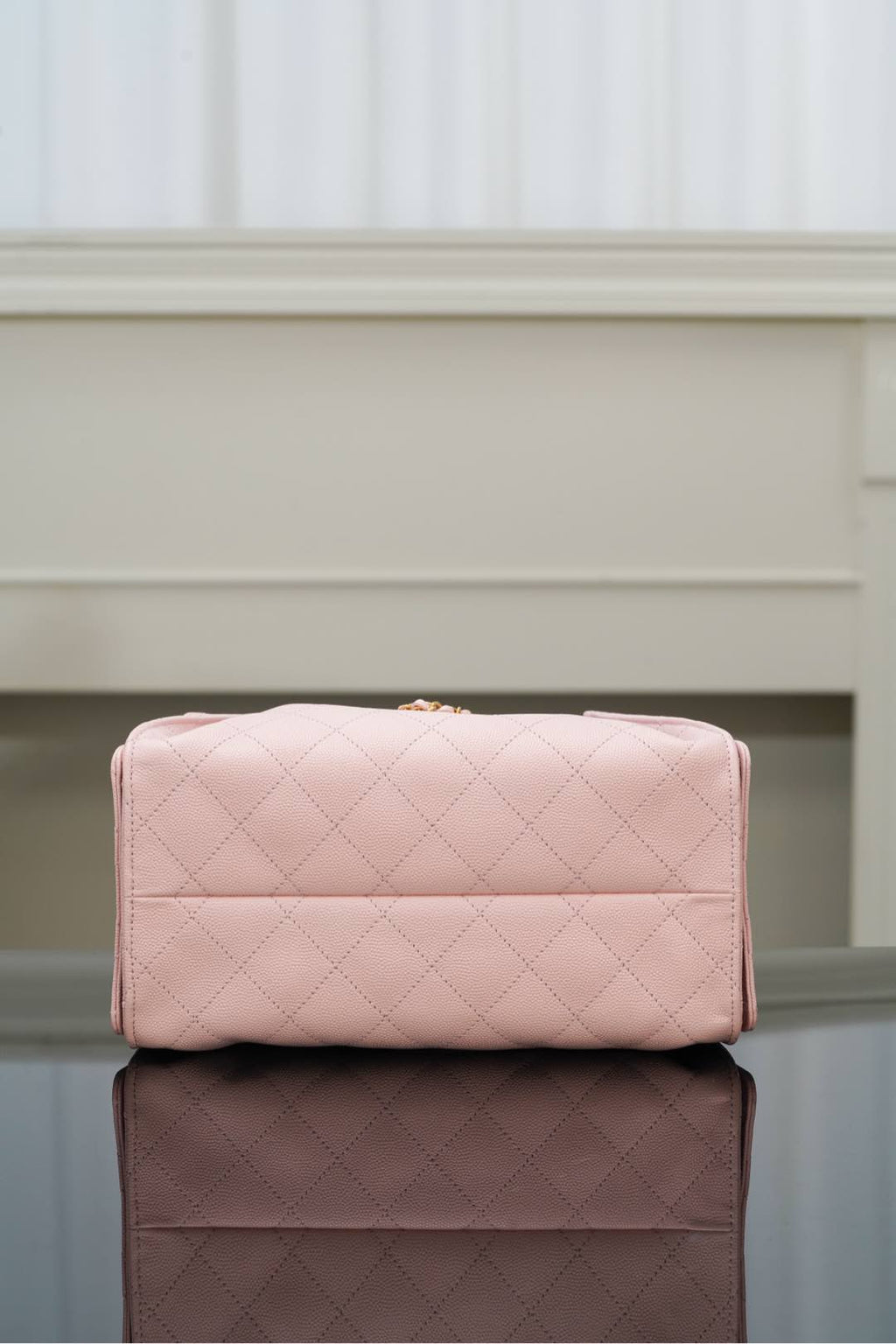 Chanel pink quilted handbag with top flap and gold hardware on front