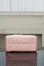 Chanel pink quilted handbag with top flap and gold hardware on front