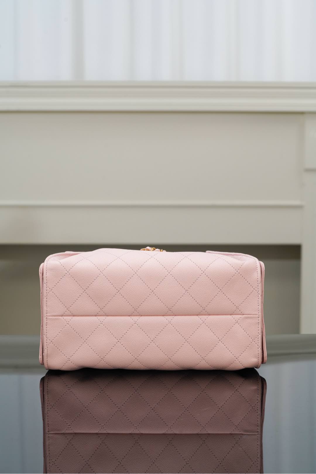 Chanel pink quilted handbag with top flap and gold hardware on front