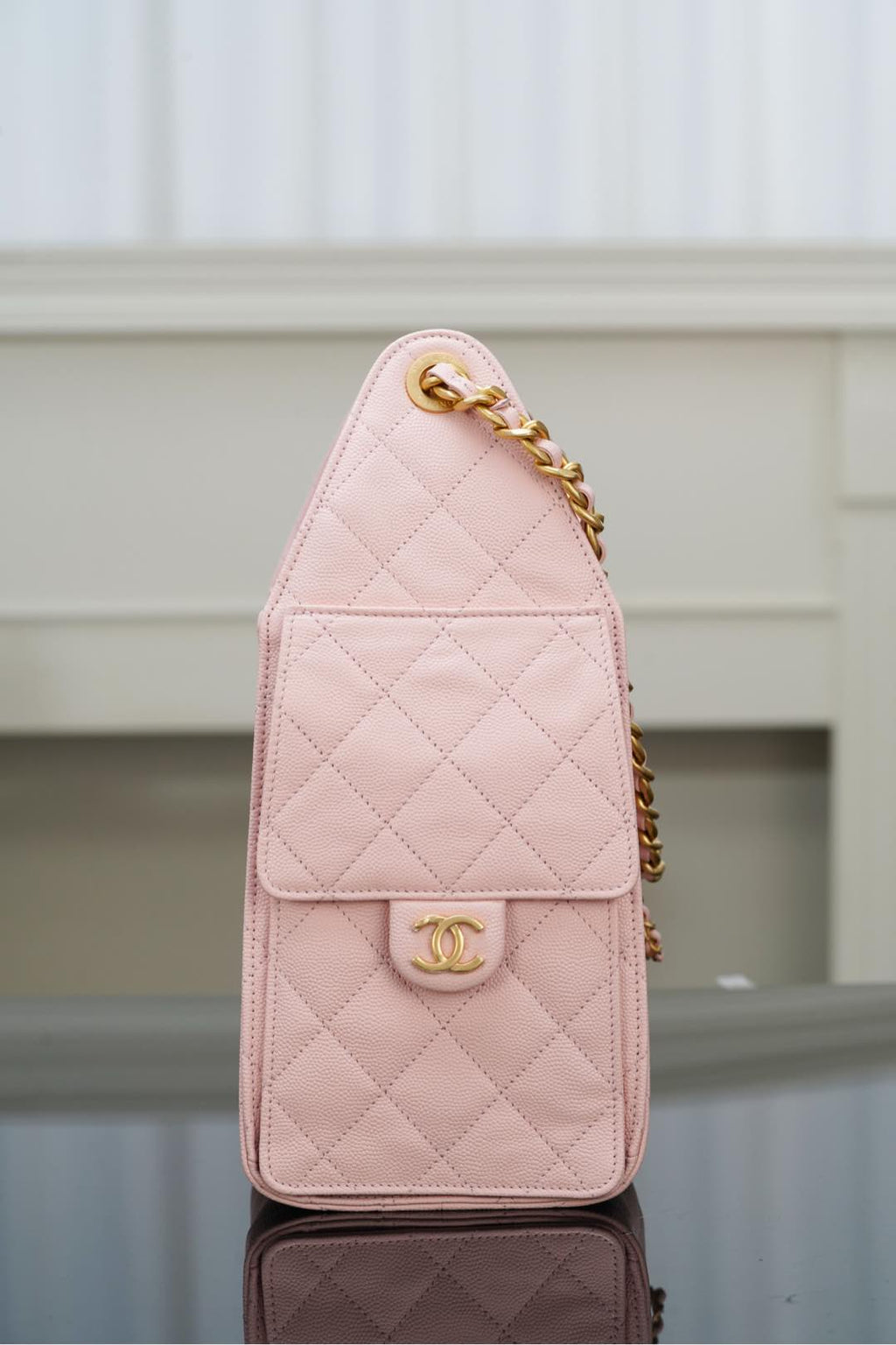 Chanel pink quilted mini bag with gold chain and front turn-lock logo