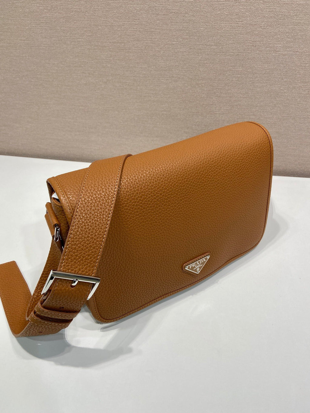 Prada leather crossbody bag, side view with adjustable belt strap and logo triangle