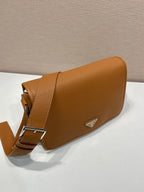 Prada leather crossbody bag, side view with adjustable belt strap and logo triangle