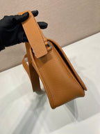Prada leather crossbody bag, close side view with adjustable strap and metal buckle
