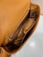 Prada leather crossbody bag interior with open top and zipper pocket, fabric lining