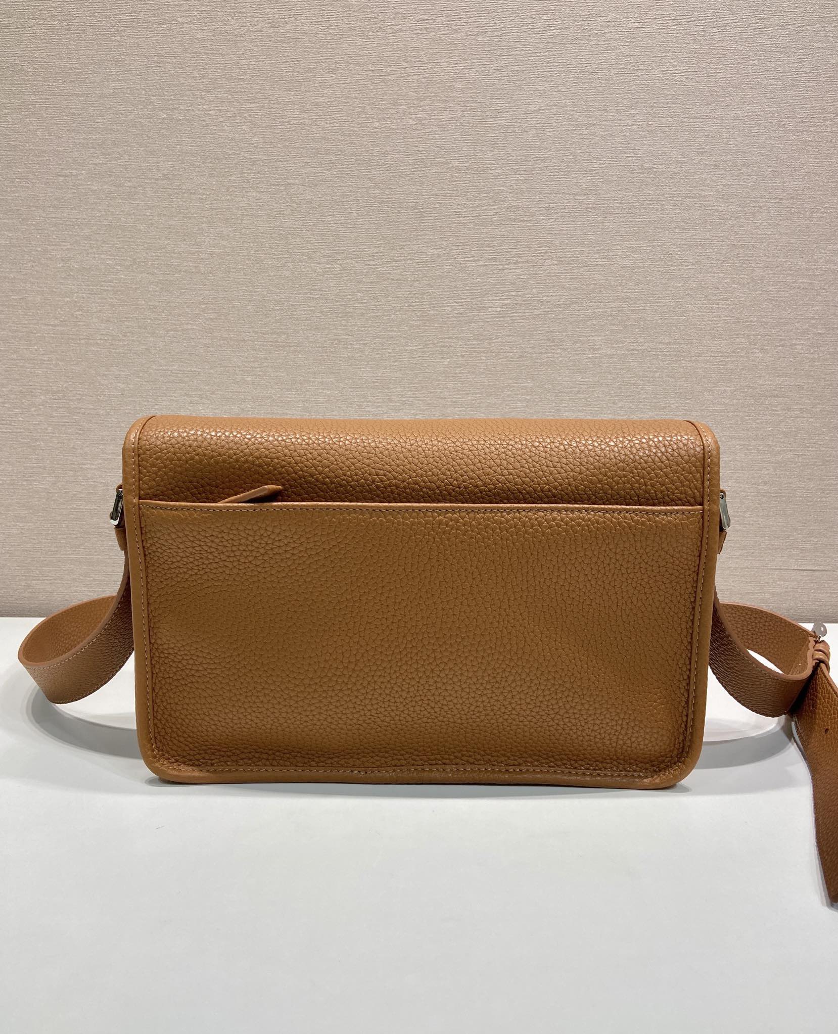 Prada leather crossbody bag with top flap, brown pebbled leather and shoulder strap