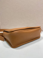 Prada leather crossbody bag, bottom corner view with side panel and strap attachment
