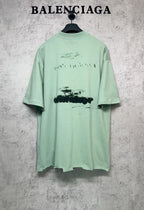 Mint green graphic T-shirt back view, crew neck and short sleeves, abstract print.