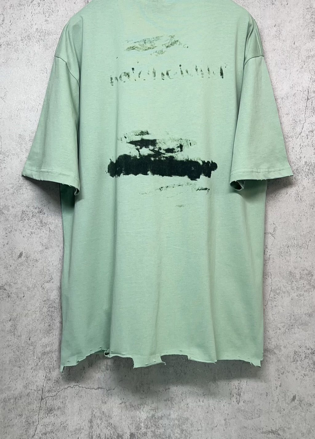 Mint green crew-neck graphic T-shirt back view with abstract logo print, short sleeves.