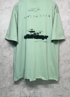 Mint green crew-neck graphic T-shirt back view with abstract logo print, short sleeves.