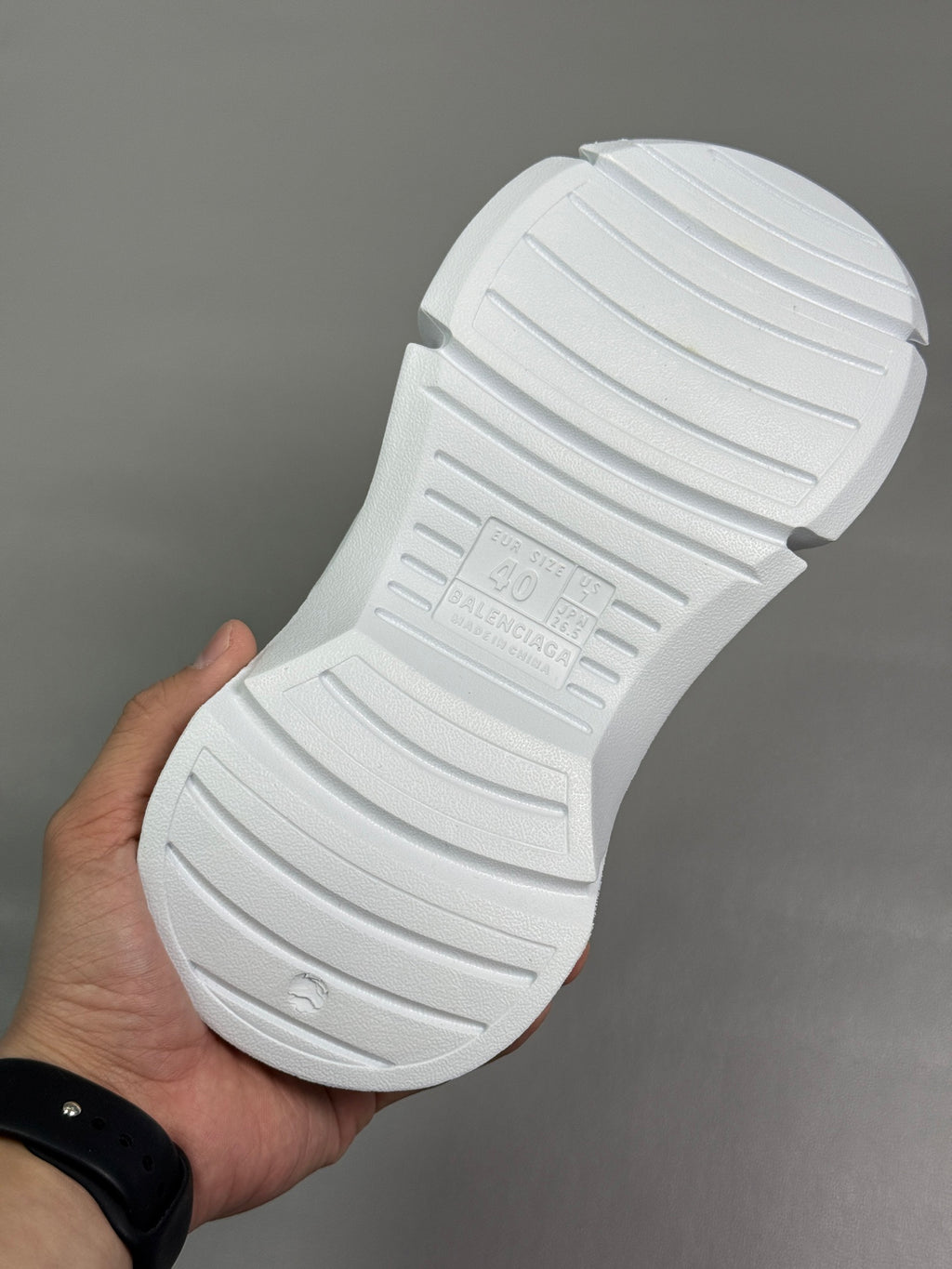 Balenciaga white slide sandal outsole with deep grooves and embossed branding