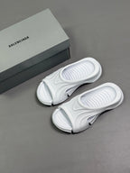 Balenciaga white slide sandals with outsoles and box beside them