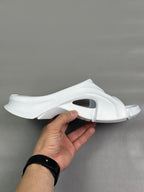 Balenciaga white slide sandals, side view with open toe and curved sole