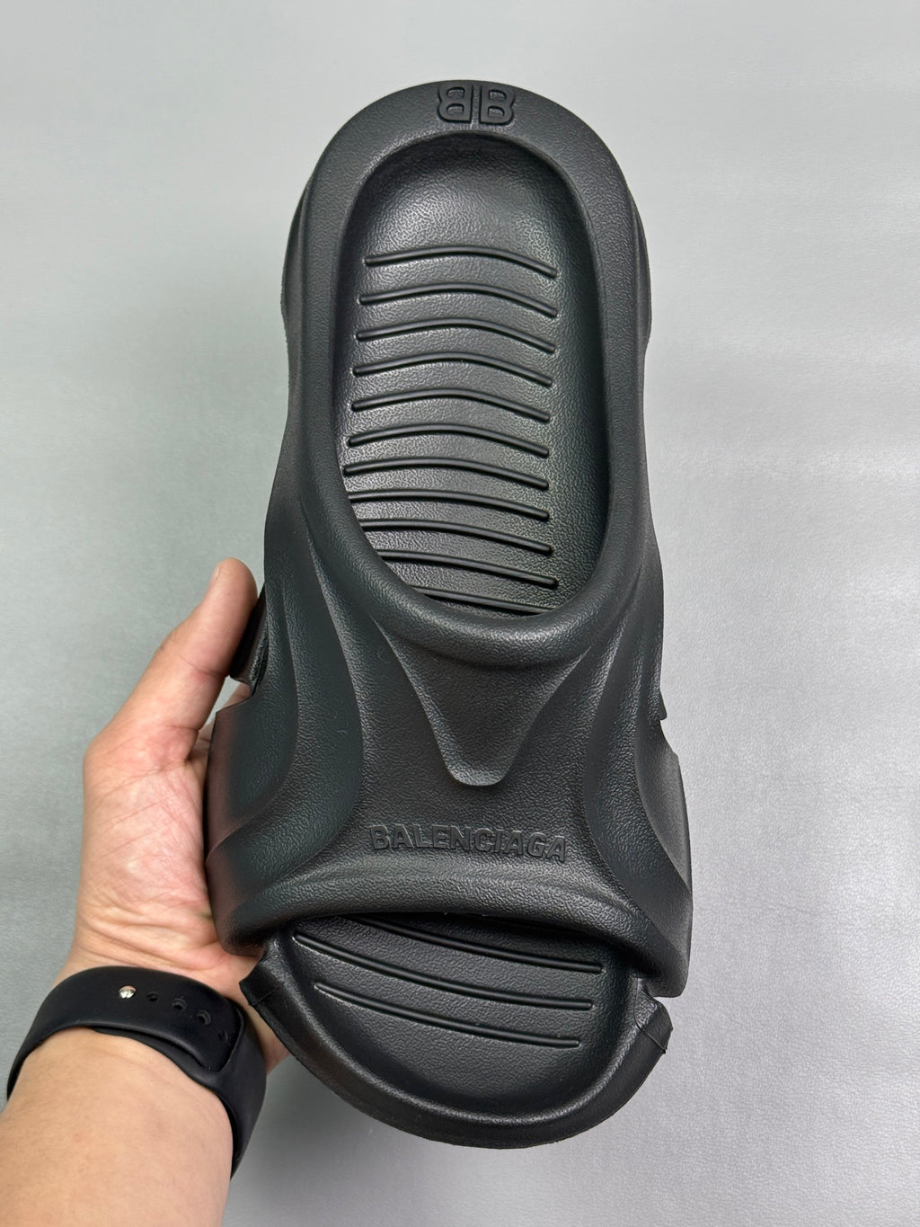 Black slide sandal with textured footbed grooves and molded arch support