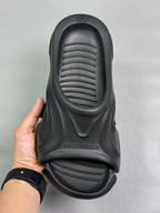 Black slide sandal with textured footbed grooves and molded arch support