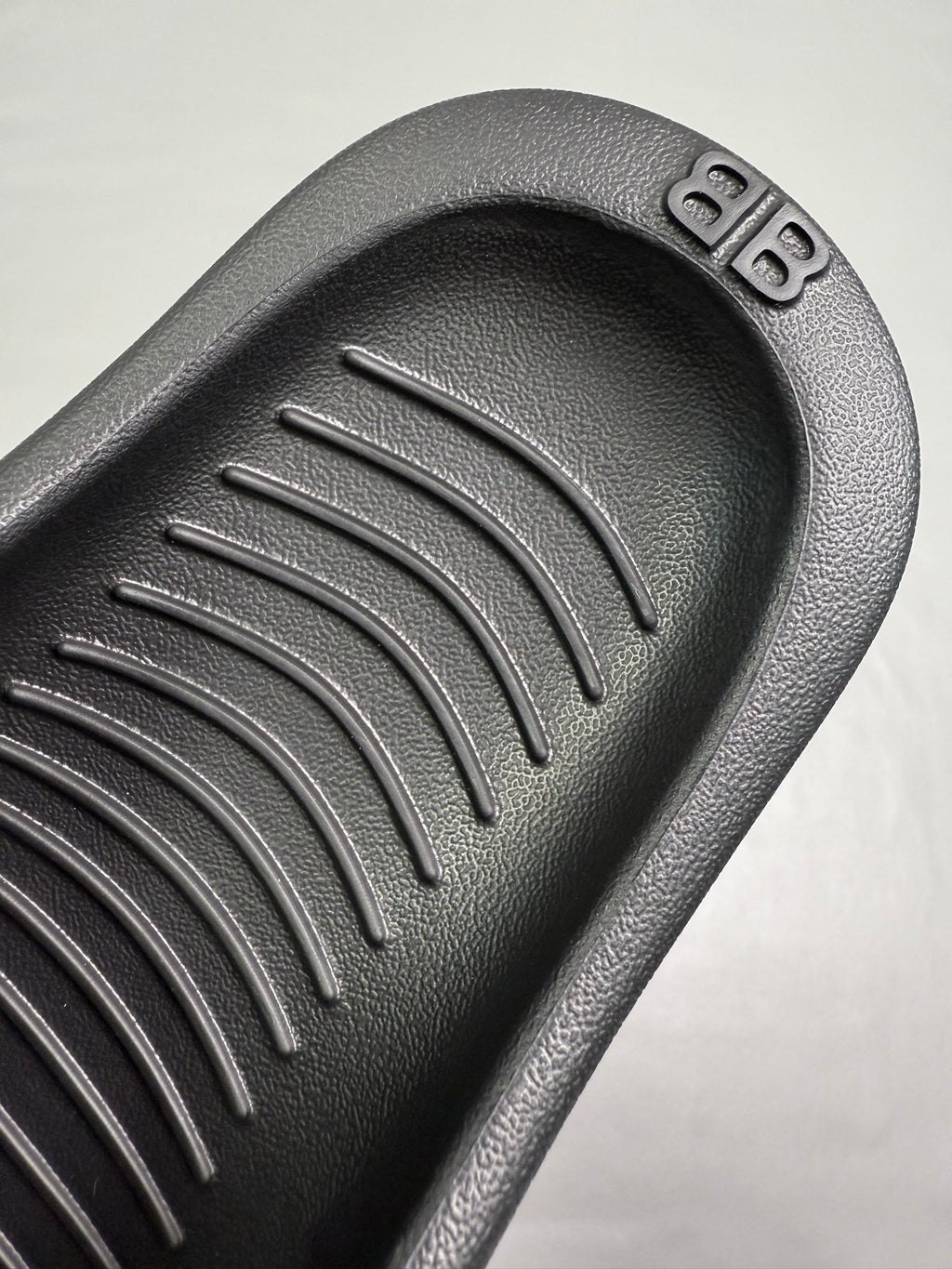 Black molded footbed with raised parallel tread channels