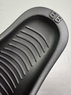 Black molded footbed with raised parallel tread channels