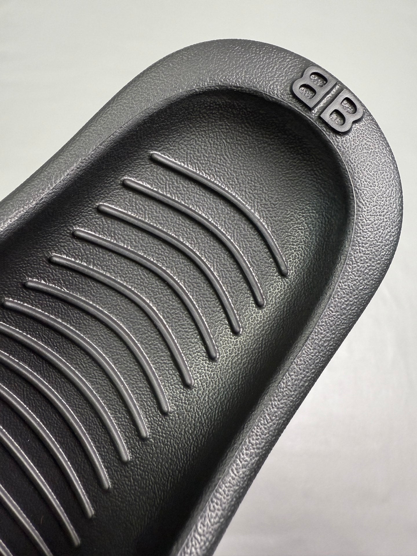 Black molded footbed with raised parallel tread channels