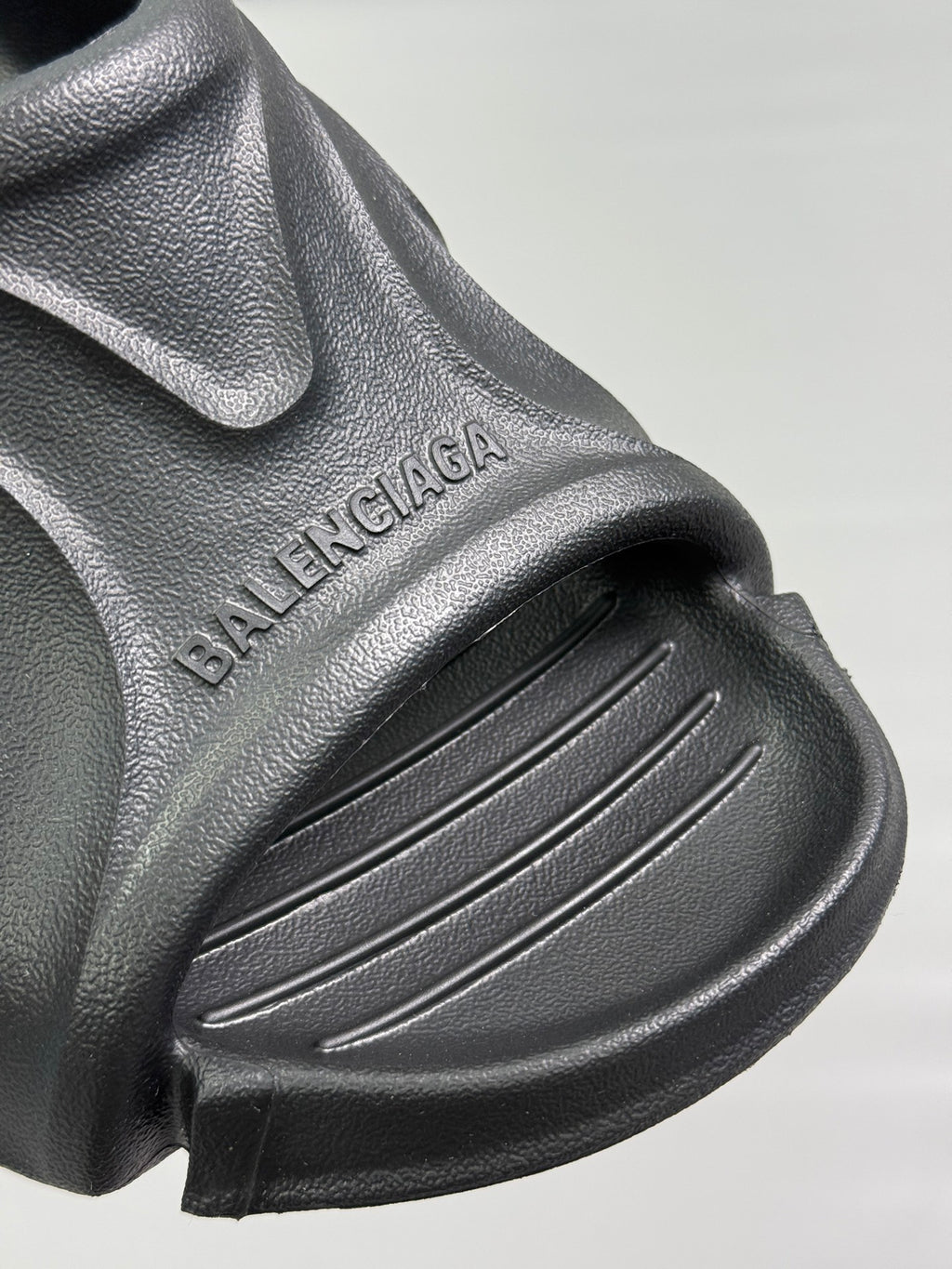 Black sandal upper with BALENCIAGA embossed text and ridged strap detail