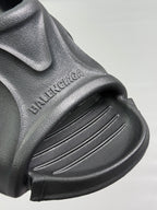 Black sandal upper with BALENCIAGA embossed text and ridged strap detail