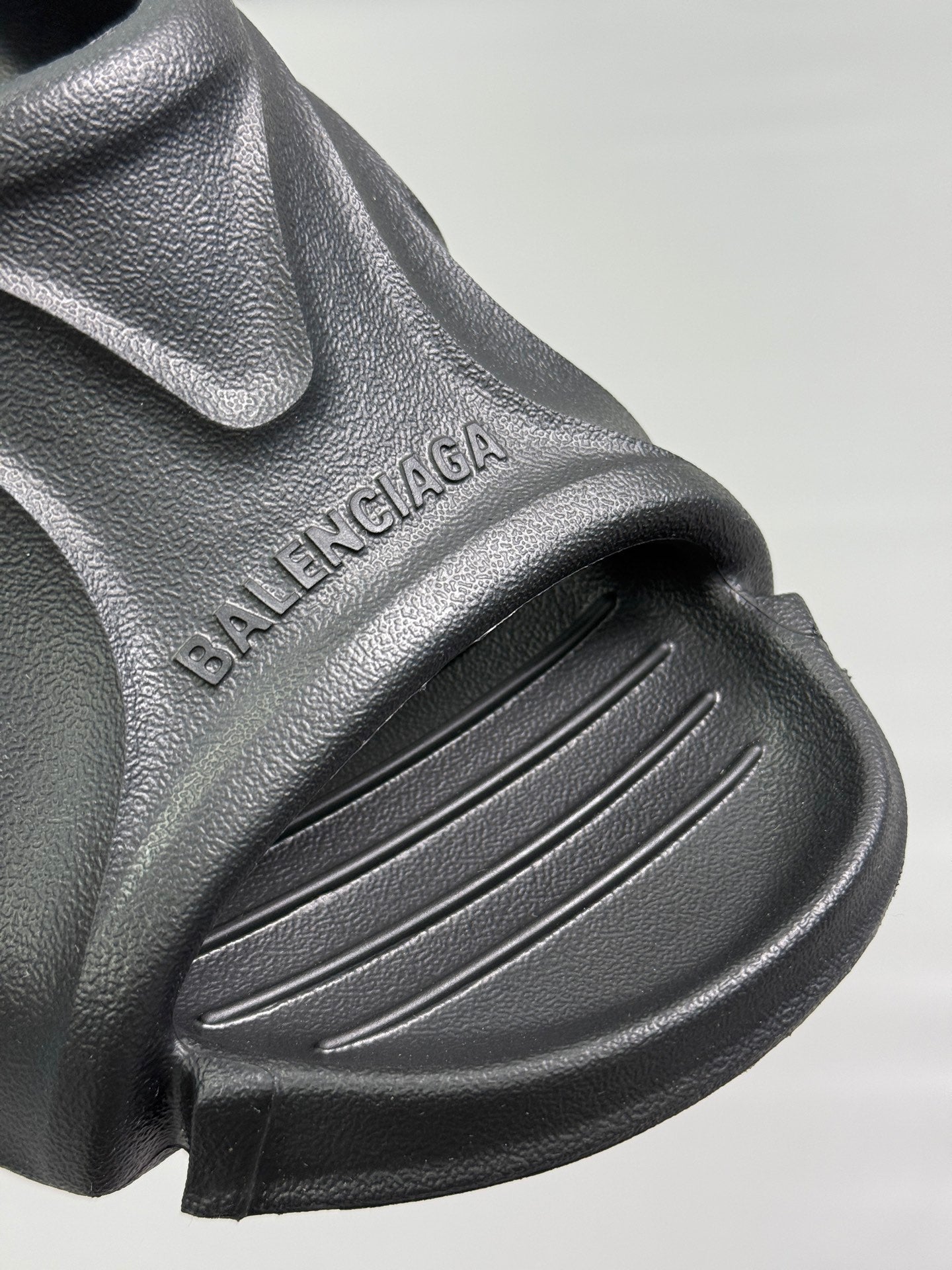 Black sandal upper with BALENCIAGA embossed text and ridged strap detail
