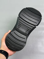 Black slide sandal outsole with deep tread lines and BALENCIAGA branding