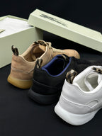 Burberry shoes angled: tan, black, and white sneakers with lace-up uppers