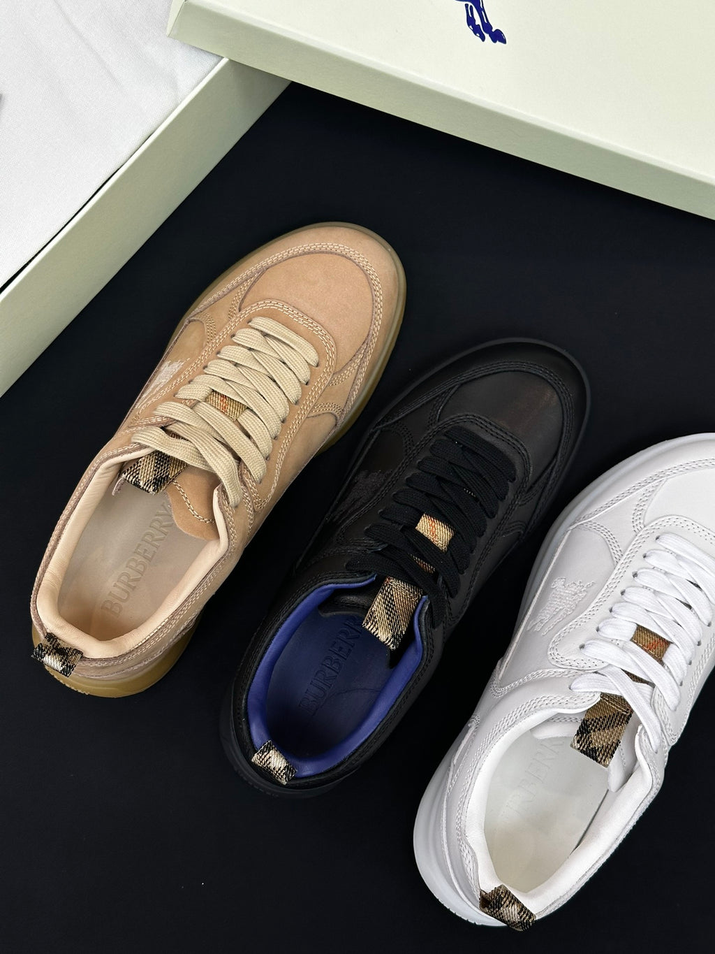 Burberry shoes close-up: beige, black, and white sneakers with lace-up details
